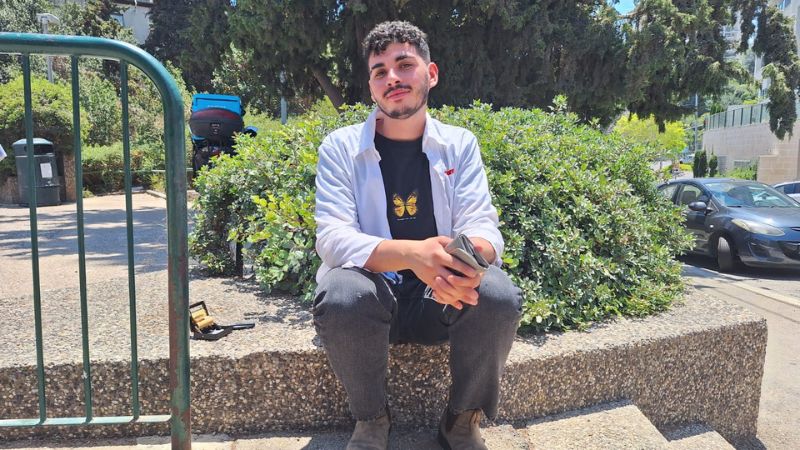 שניאור, עובד בקופה של סופר להב בהפסקת סיגריה | צילום: עומר מוזר