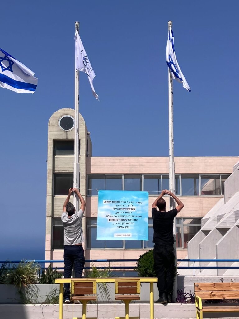תליית שלט עם מטרות חוק החינוך הממלכתי במרכז החינוך ליאו באק | צילום: המשמרות המקומיים